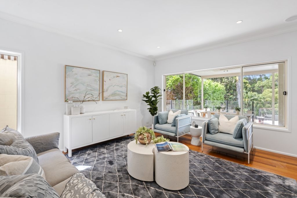 A living room filled with furniture and a large window.
