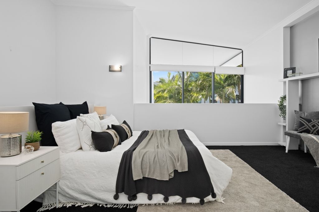 A bedroom with a large bed and a window