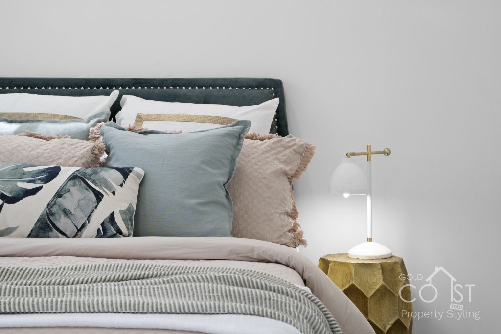 A bed with a lot of pillows on it