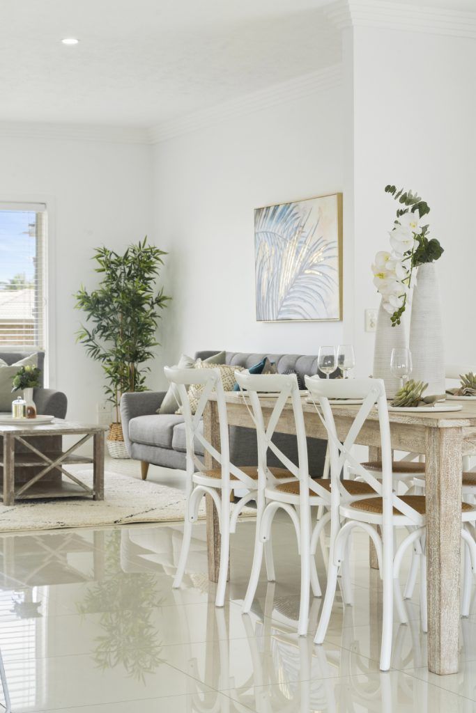 A living room with a dining table and chairs and a couch.