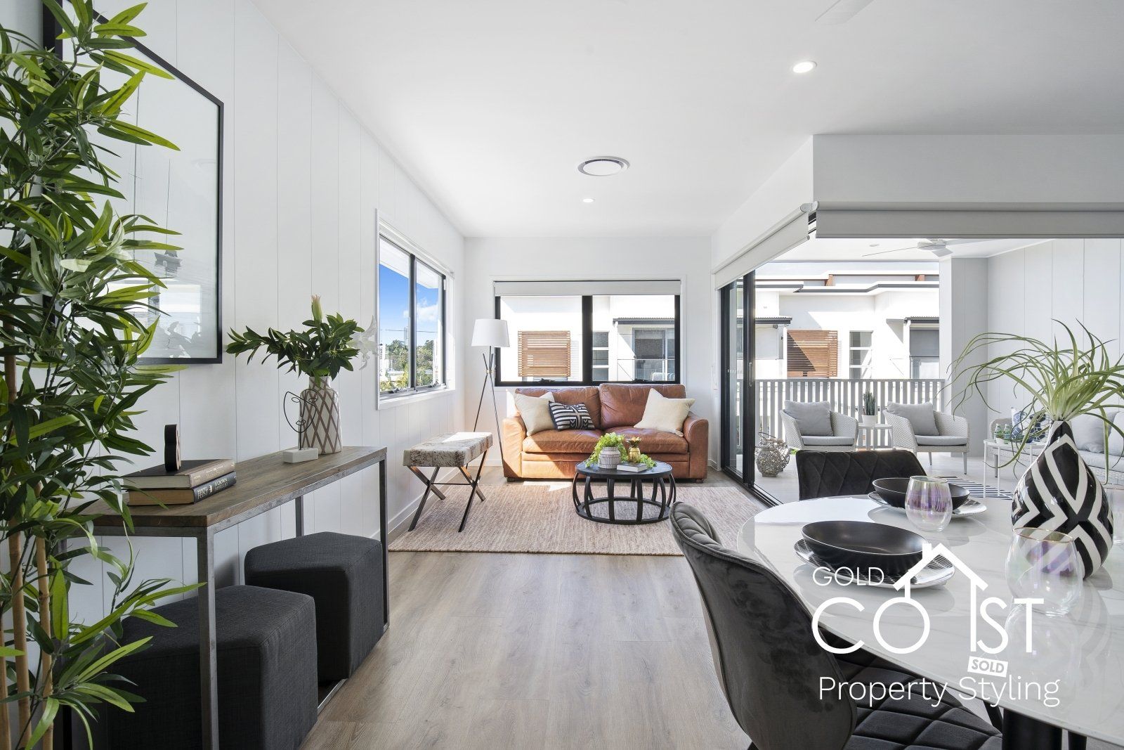 A living room with a couch , table and chairs.
