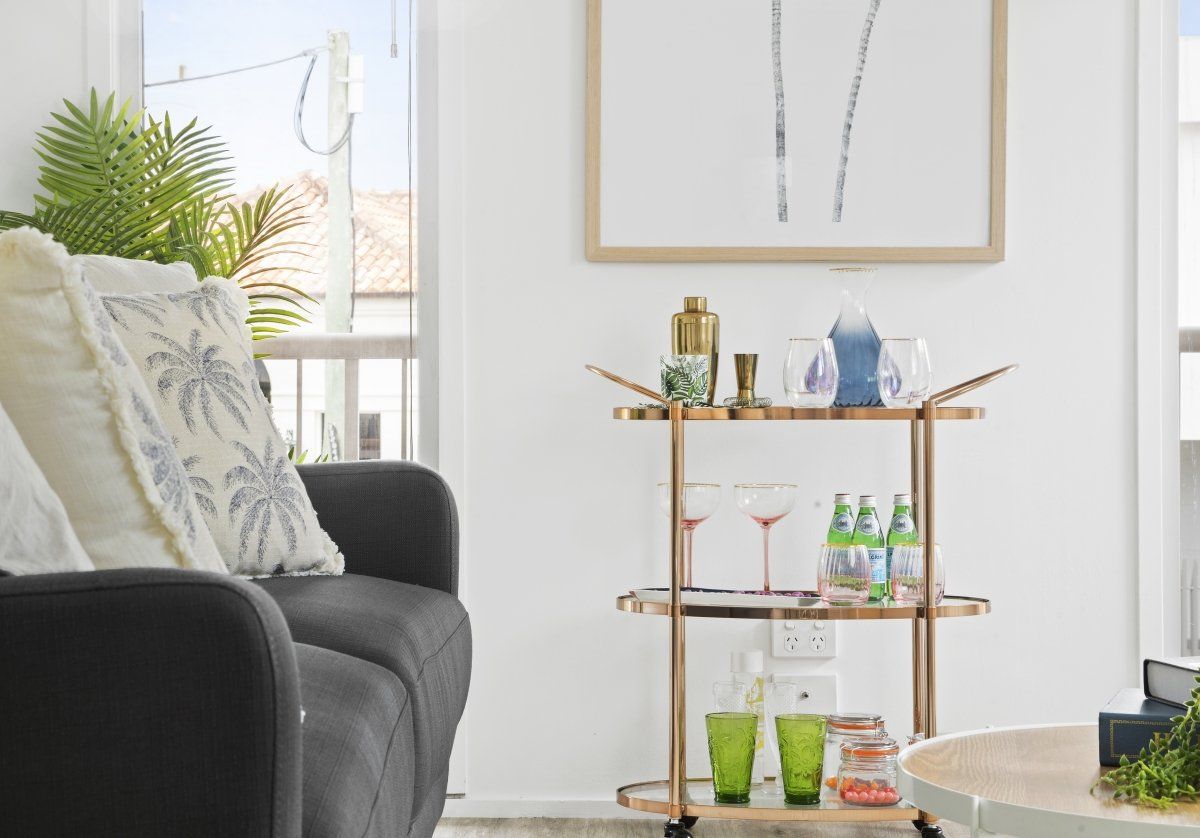 A living room with a bar cart and a couch.
