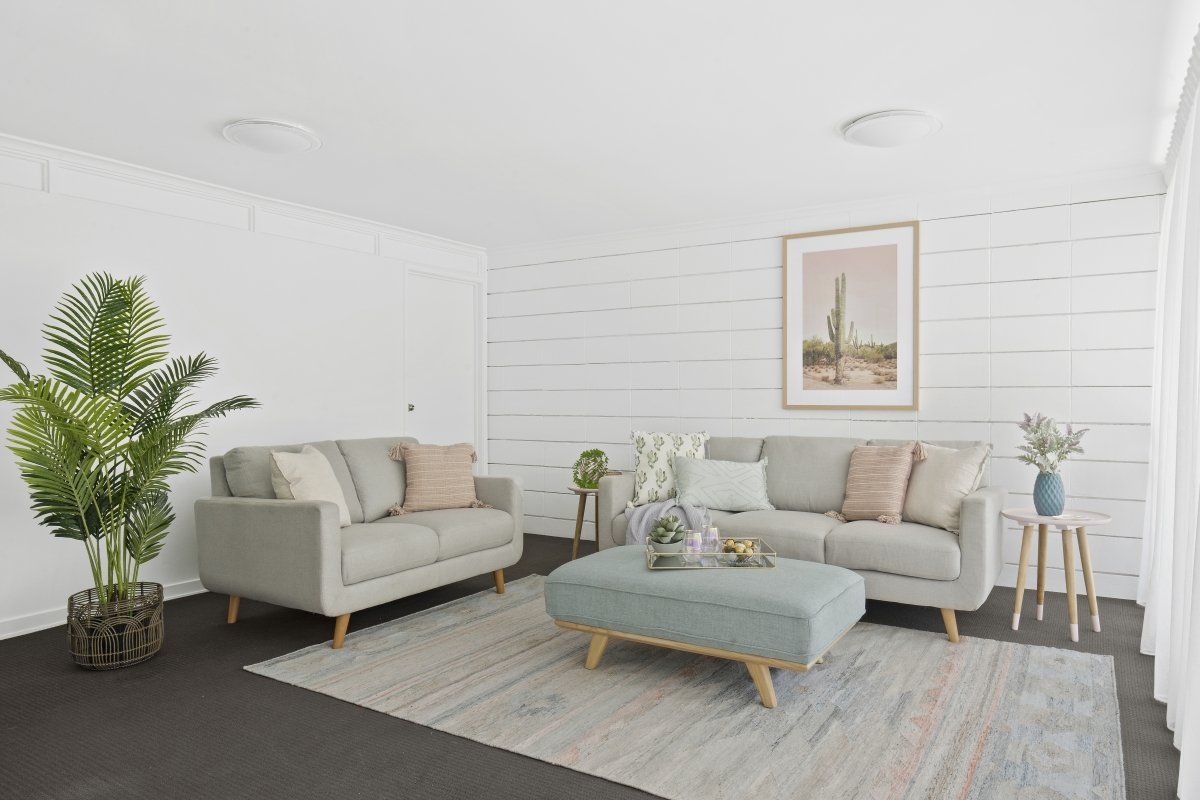 A living room with two couches and a coffee table.