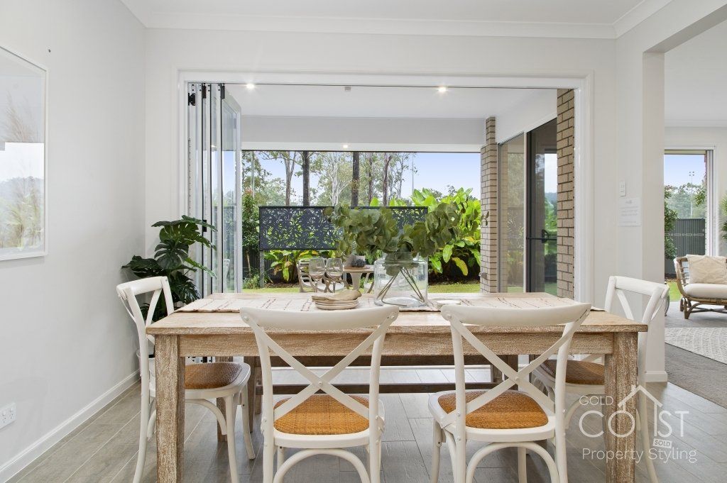 A dining room with a wooden table and chairs
