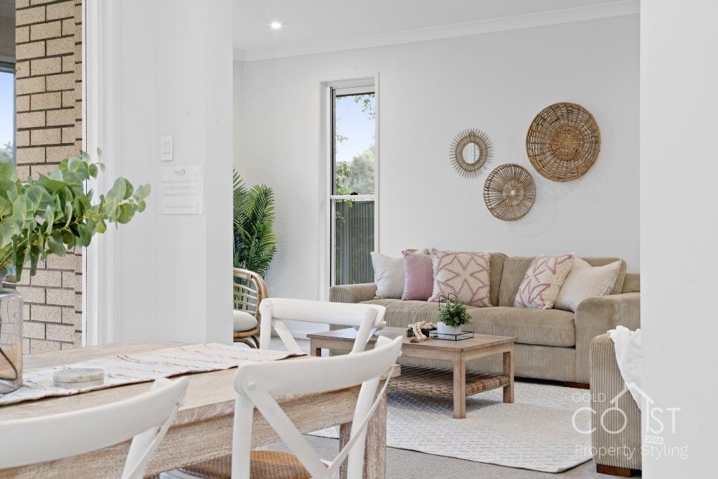 A living room with a couch , table and chairs
