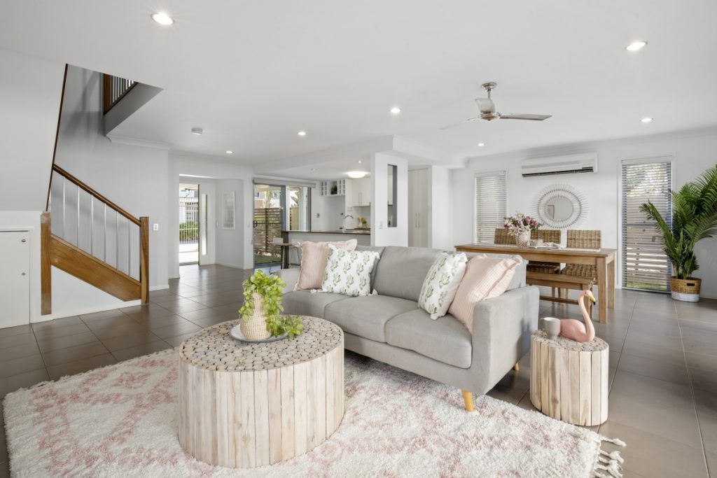 A living room with a couch , table , and rug.