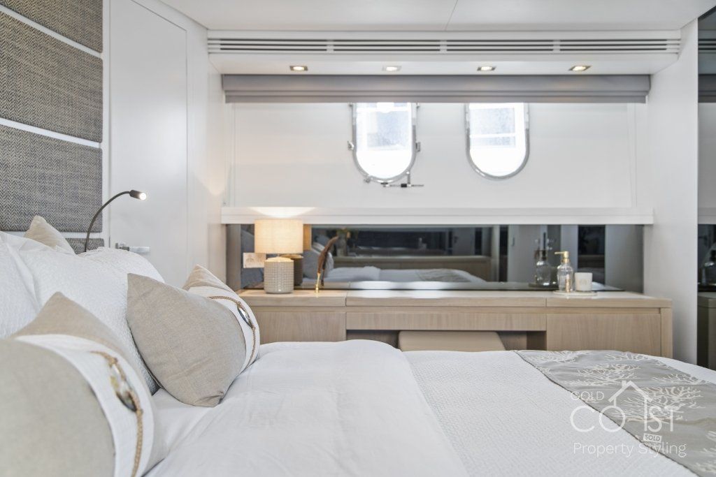 A bedroom on a boat with a bed and a window