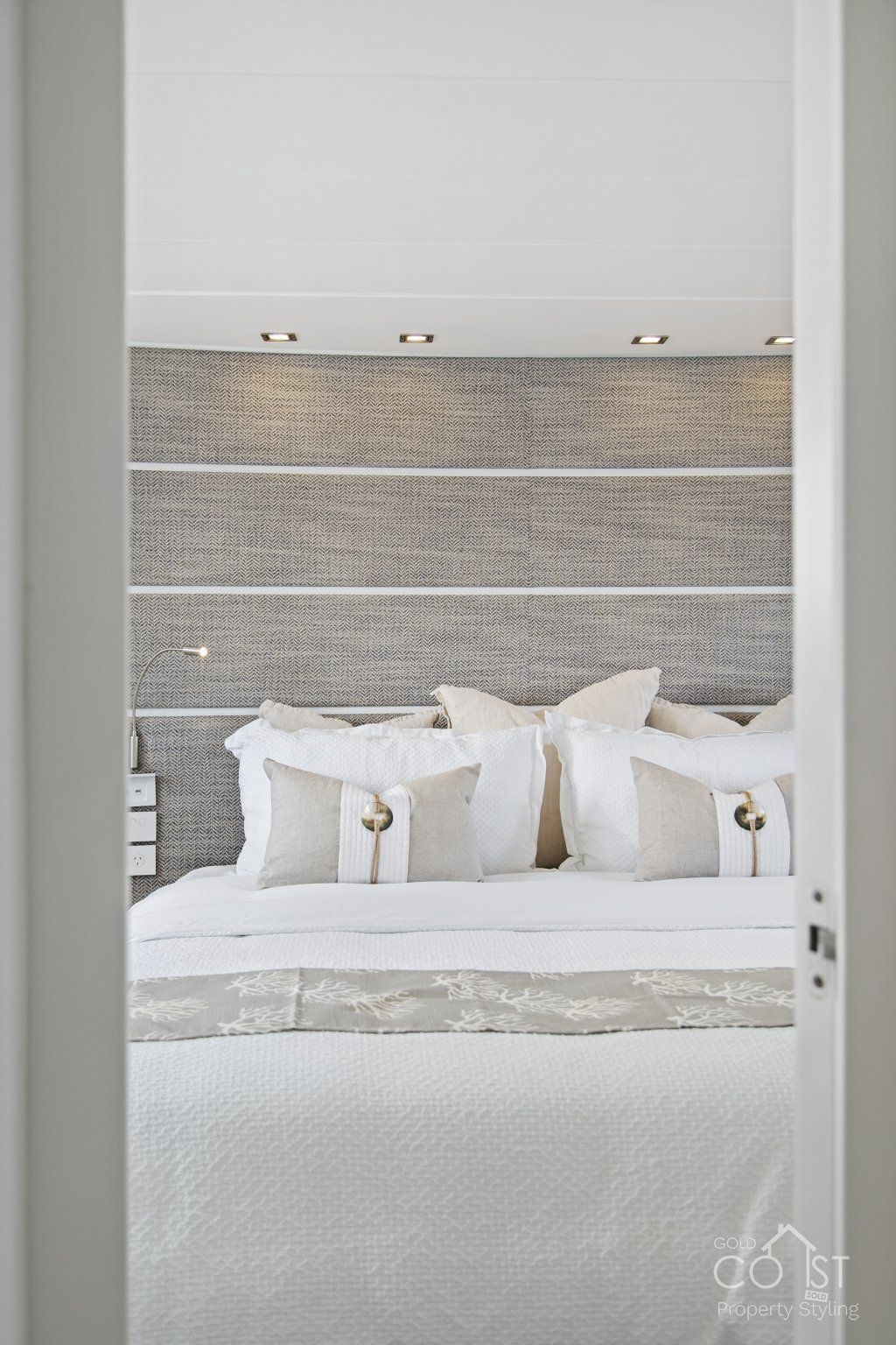 A bedroom with a bed and a door leading to it.