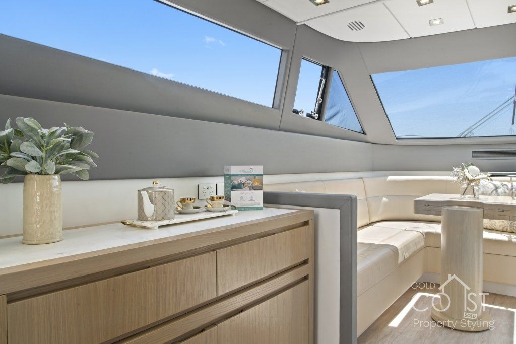 A living room on a boat with a table and couch.