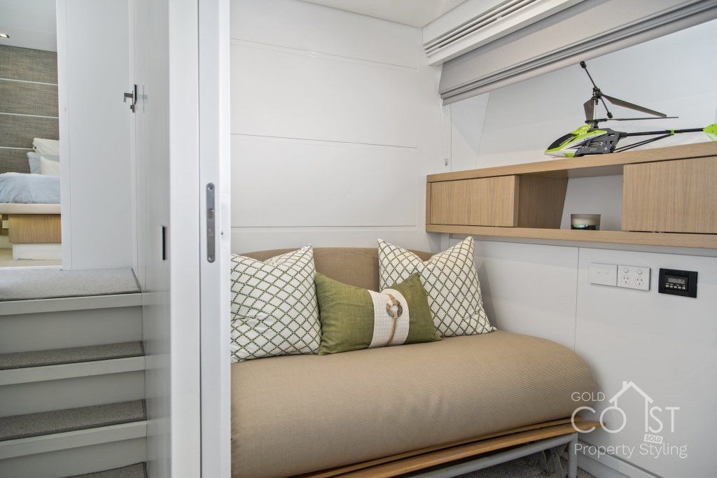 A small room with a couch and pillows in it