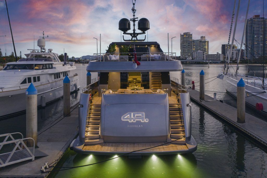 A large yacht is docked at a marina.