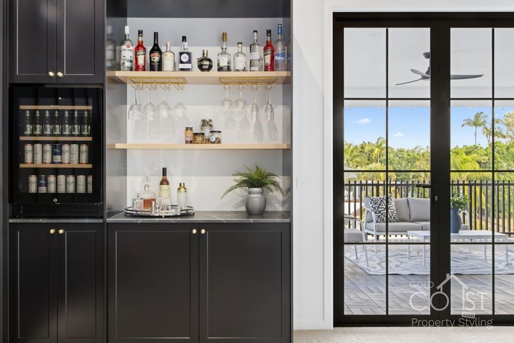 A kitchen with a bar and a sliding glass door