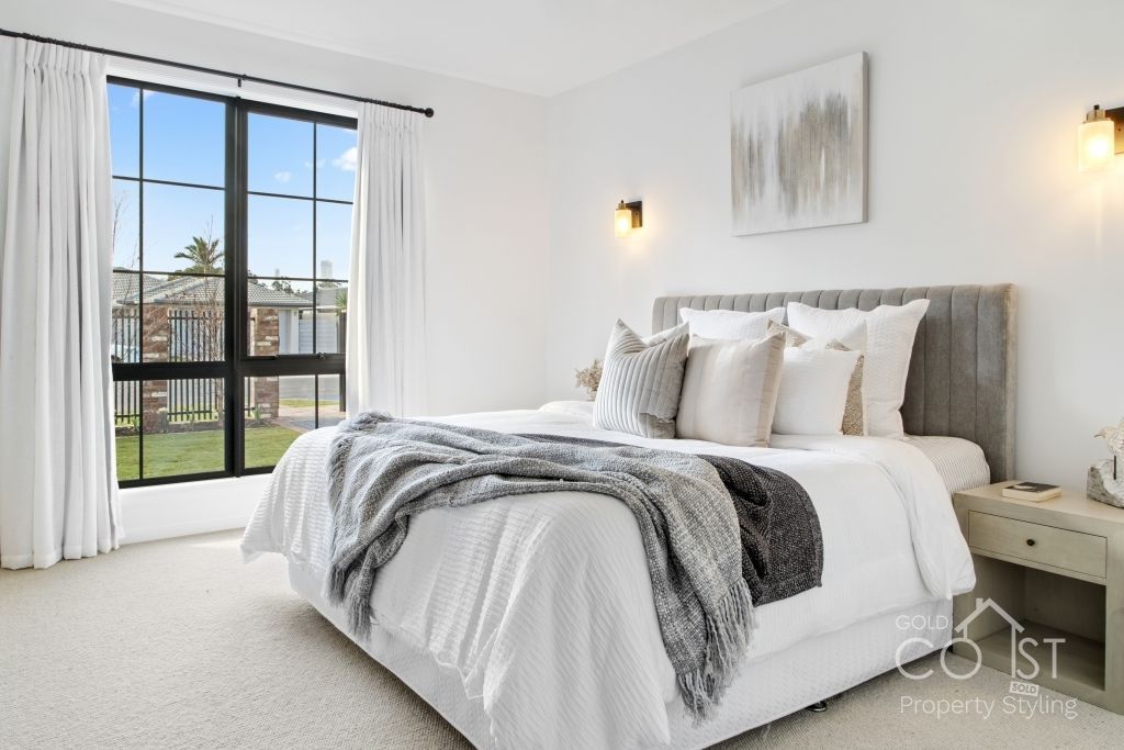 A bedroom with a large bed and a window