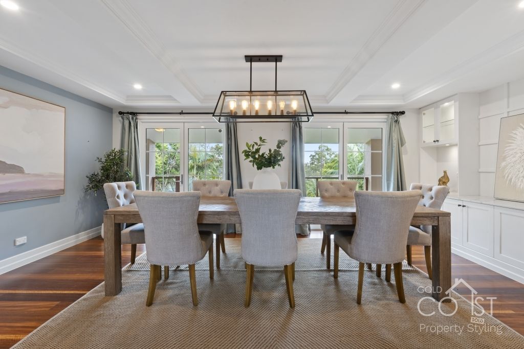 A dining room with a long table and chairs