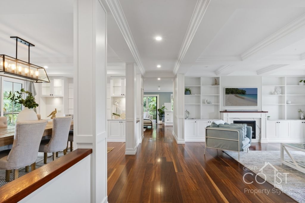 A living room with hardwood floors and white walls