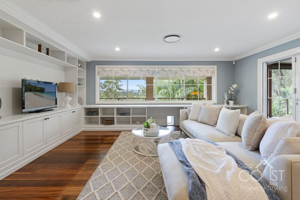 A living room with a couch , table , and television.