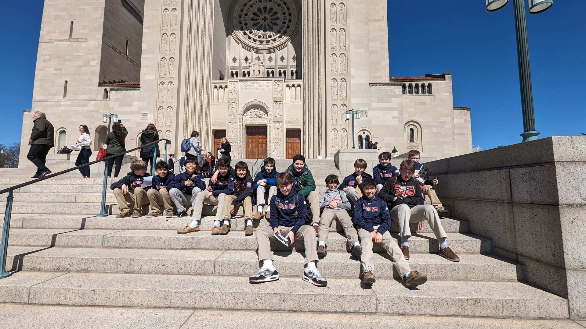 Sixth grade boys enjoy the sun outside the Bascilica.