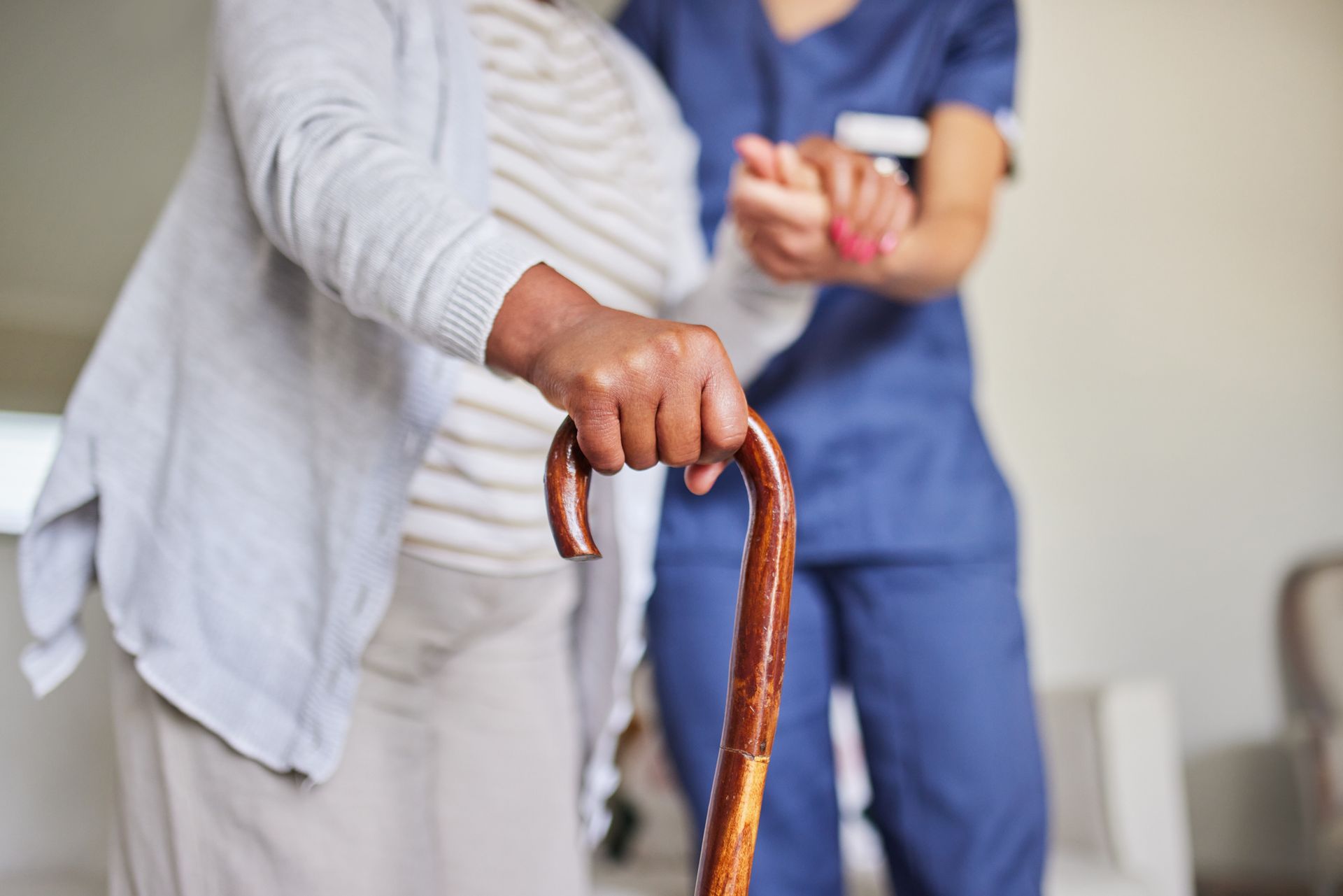 Business team in suits at a table, reviewing documents. Modern setting with neutral tones.
