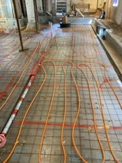 A bunch of wires are laying on the floor of a building.