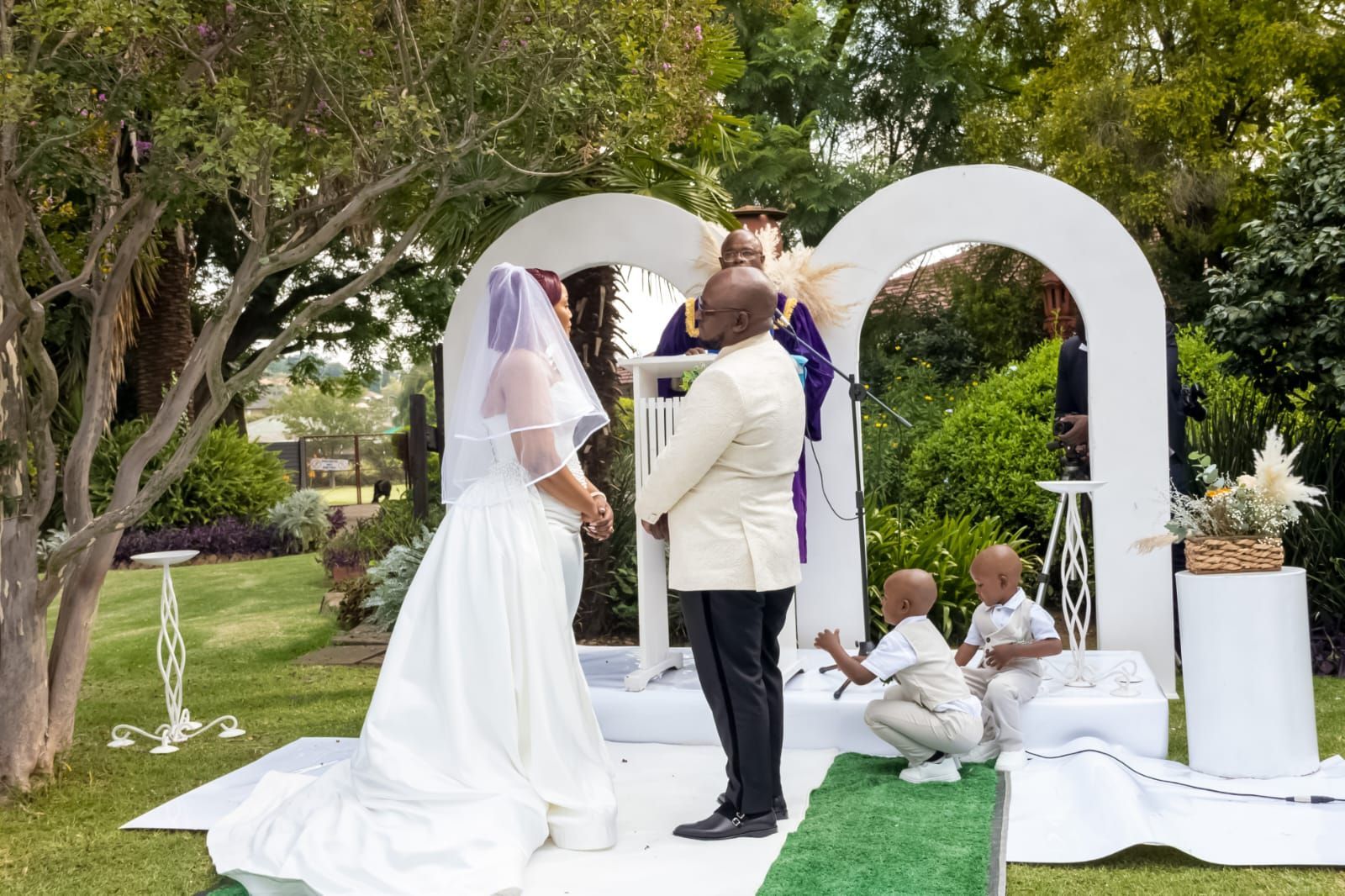 A group of people are sitting around a table with laptops.