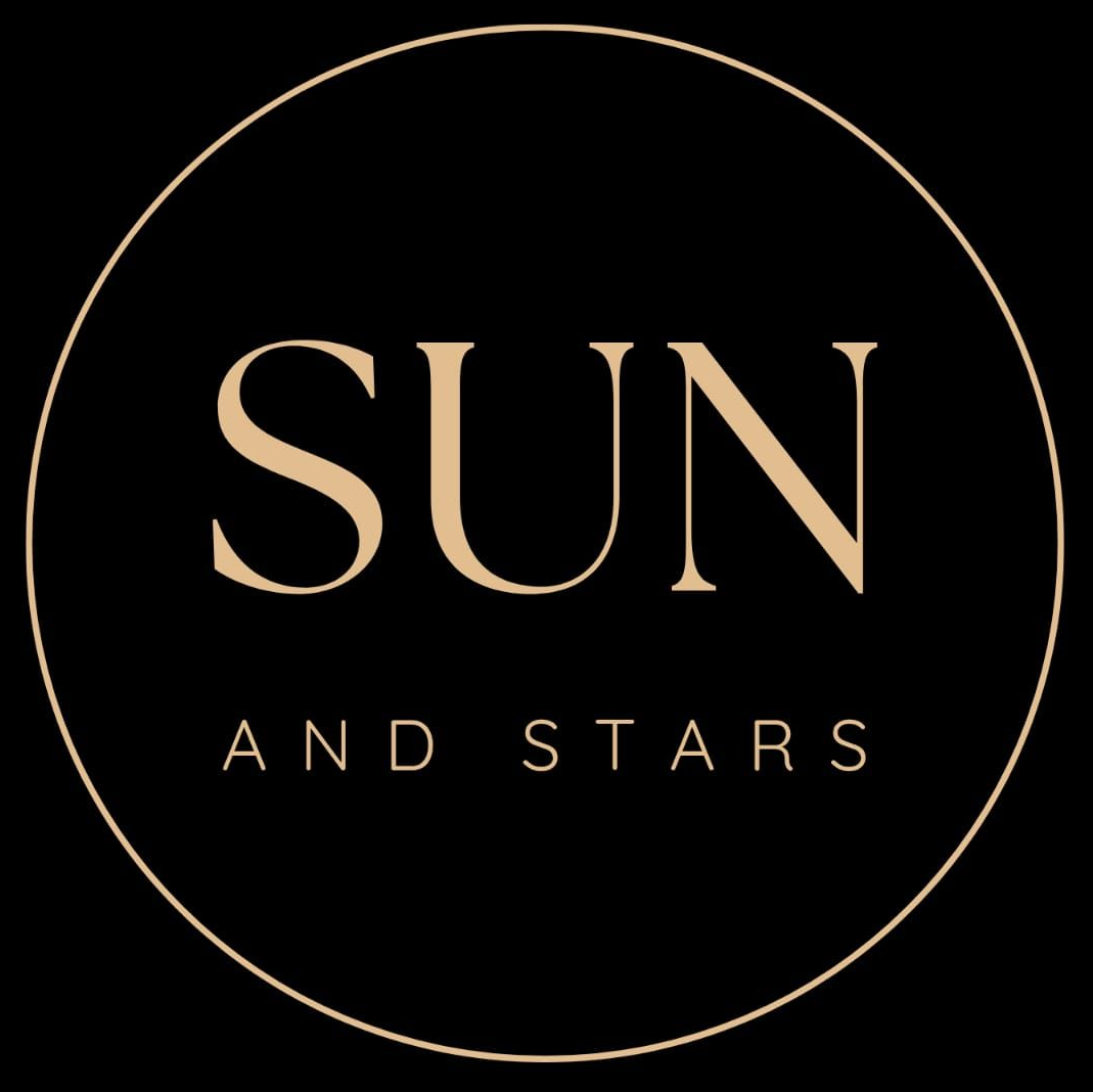 A gold star with the words sun & stars on it