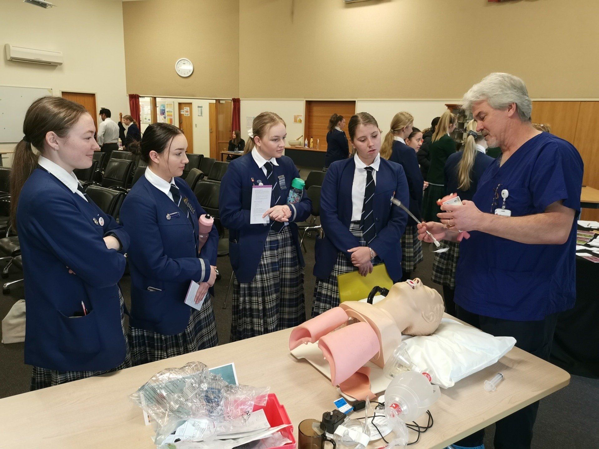 Timaru Girls Hig School | A group of people are standing around a table with a mannequin on it.