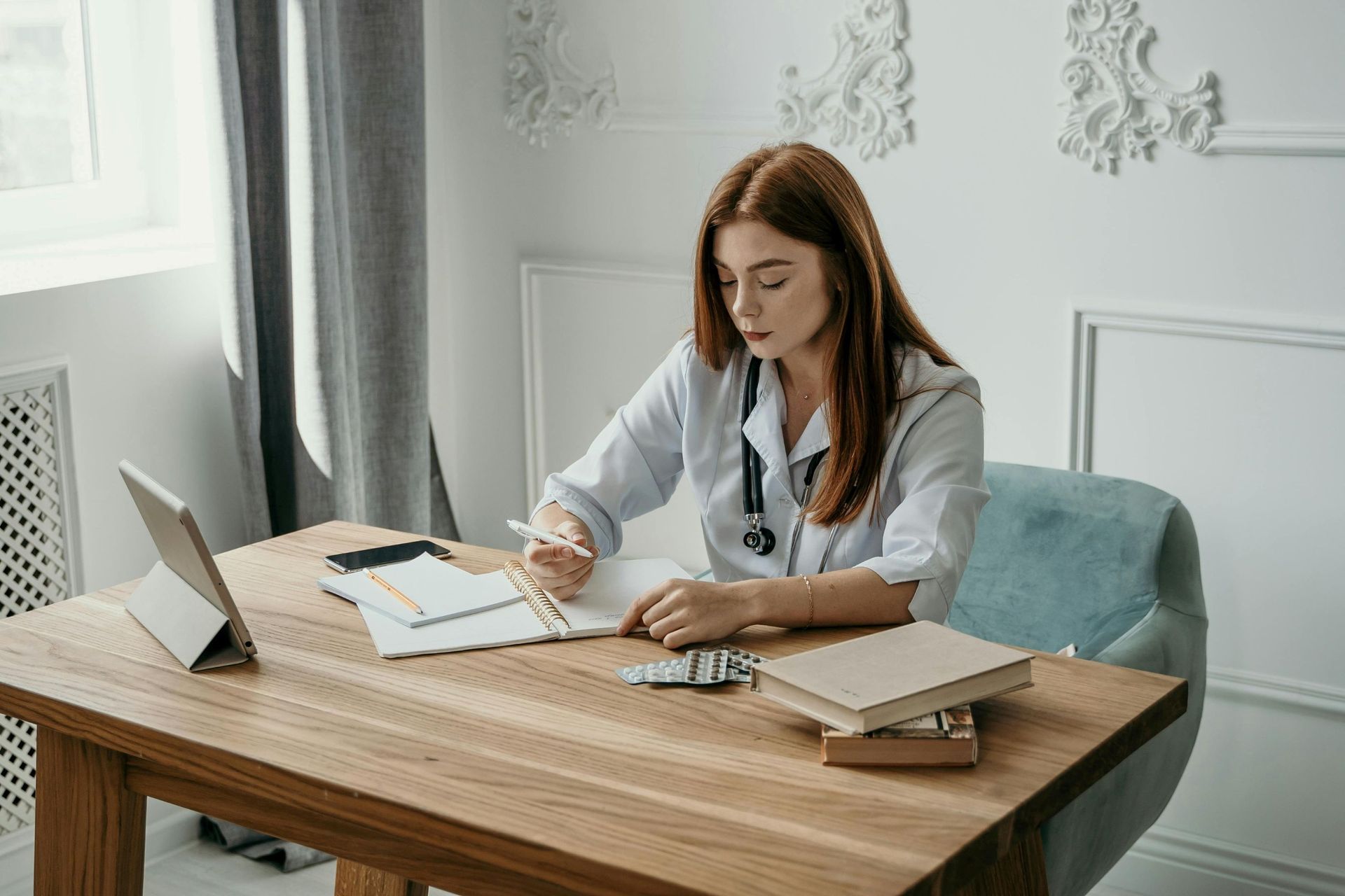 Female doctor writing down notes.