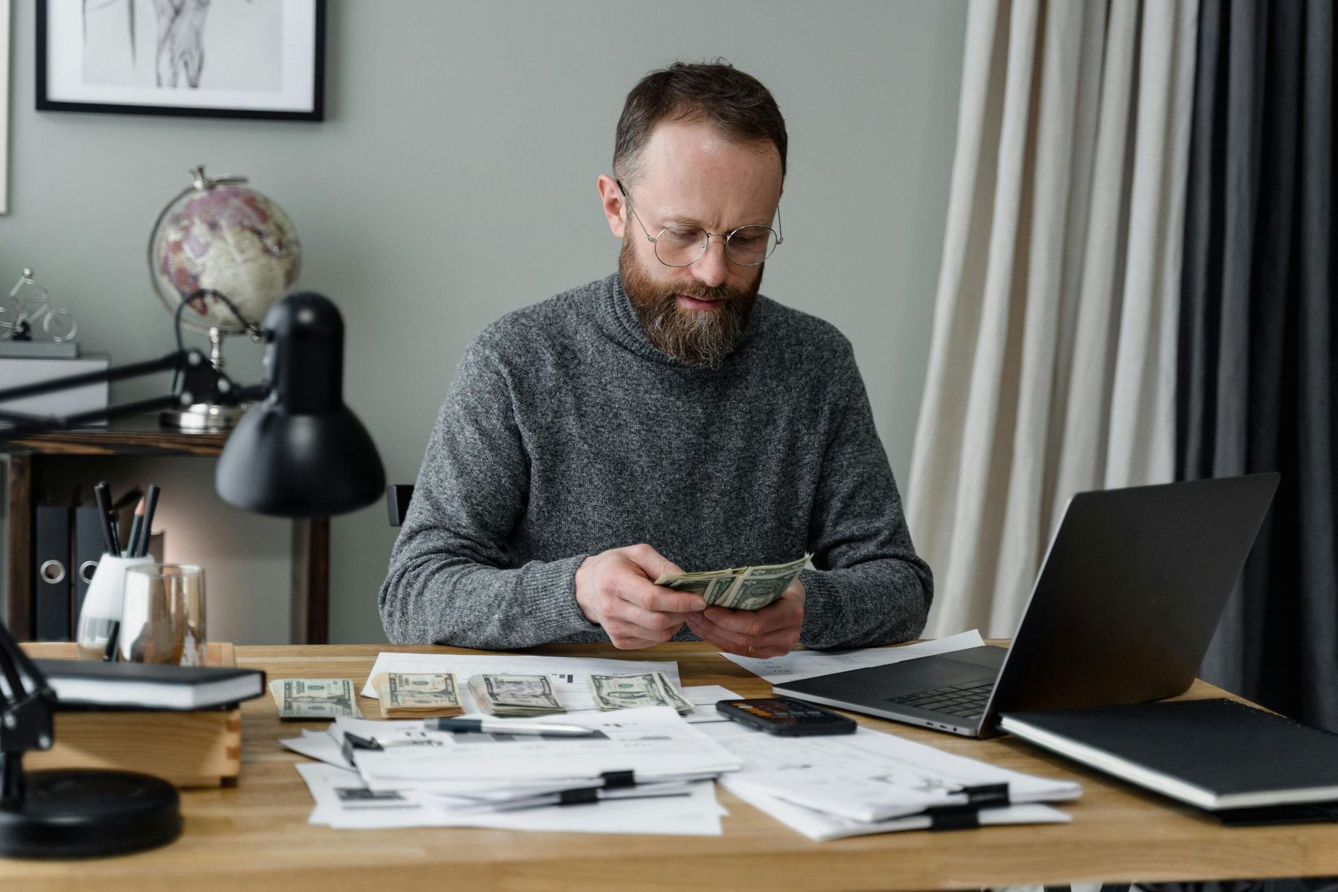 business owner counting cash: Ipswich accountants help business owners with cashflow & profit.