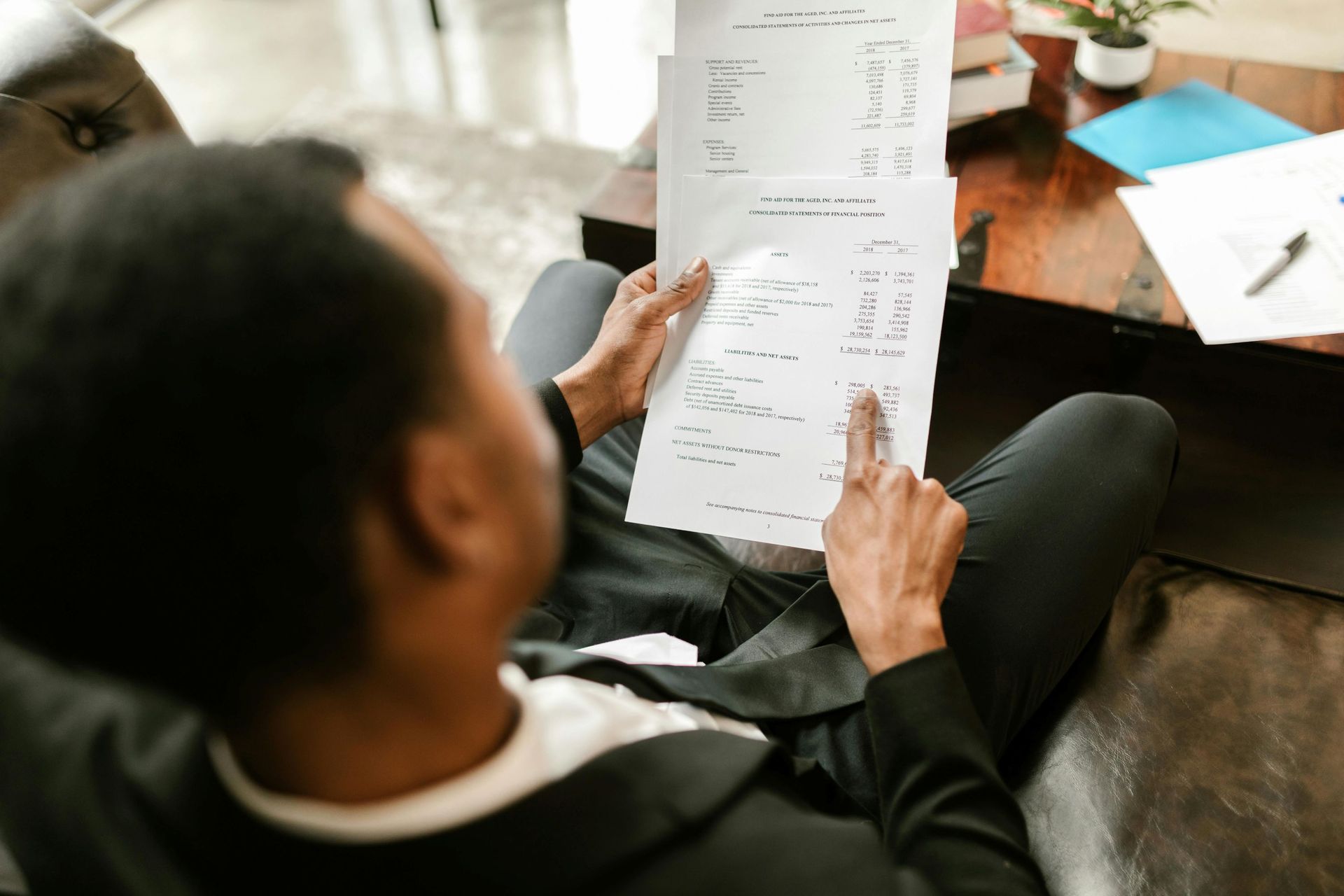 male looking at financial document.