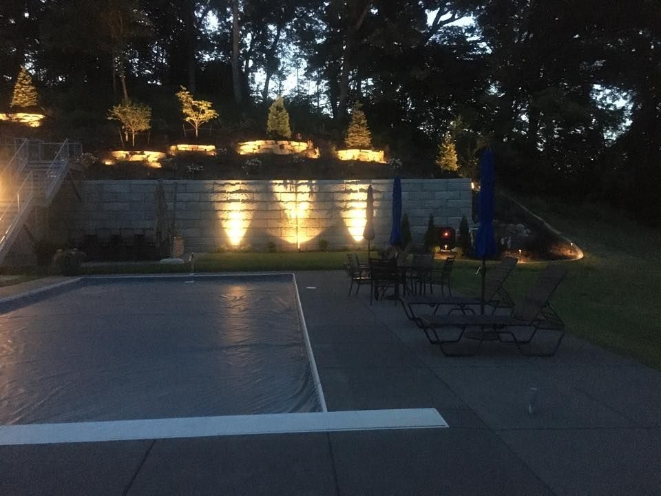 A large swimming pool is lit up at night