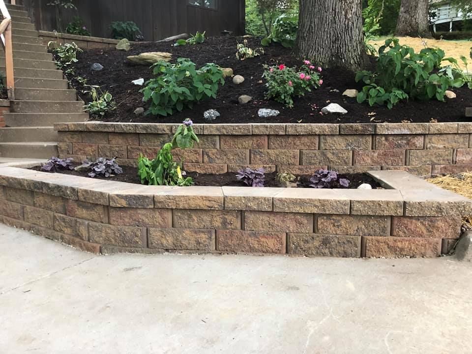 A brick wall with a planter in the middle of it.