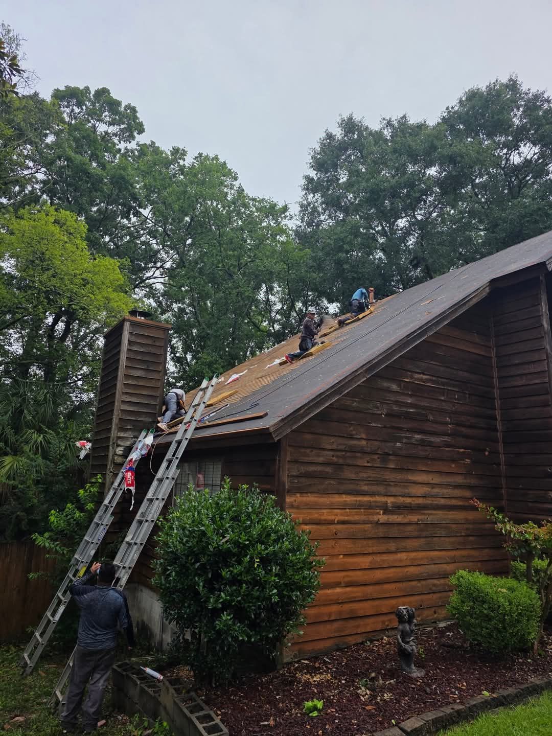 Brown shingle roof with a triangular gable featuring an arched window with white trim.