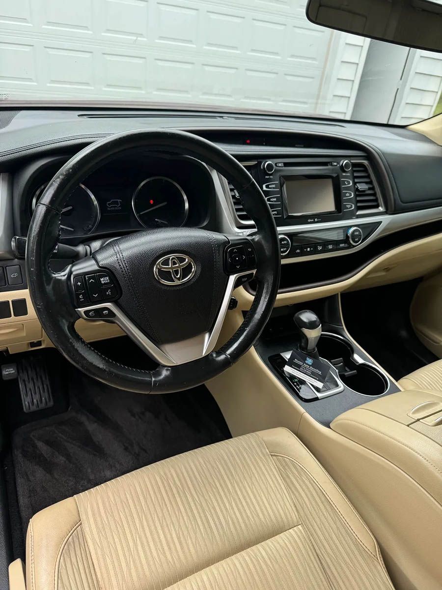 The interior of a toyota highlander with a steering wheel and dashboard.