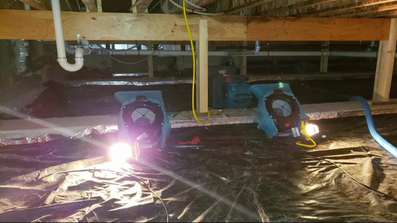 Crawl space repair with drying equipment and vapor barrier installed
