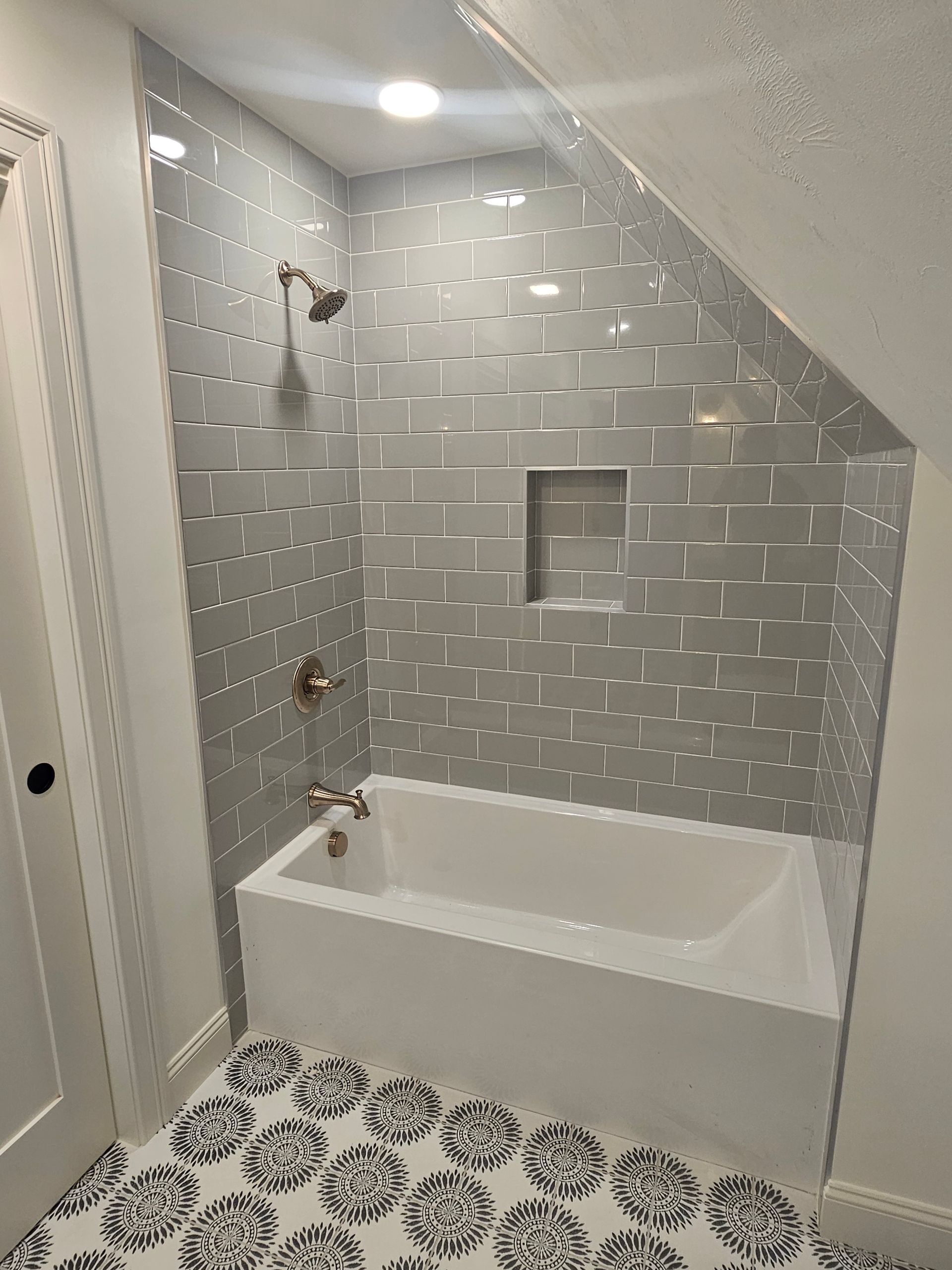 A bathroom with a bathtub and a shower.
