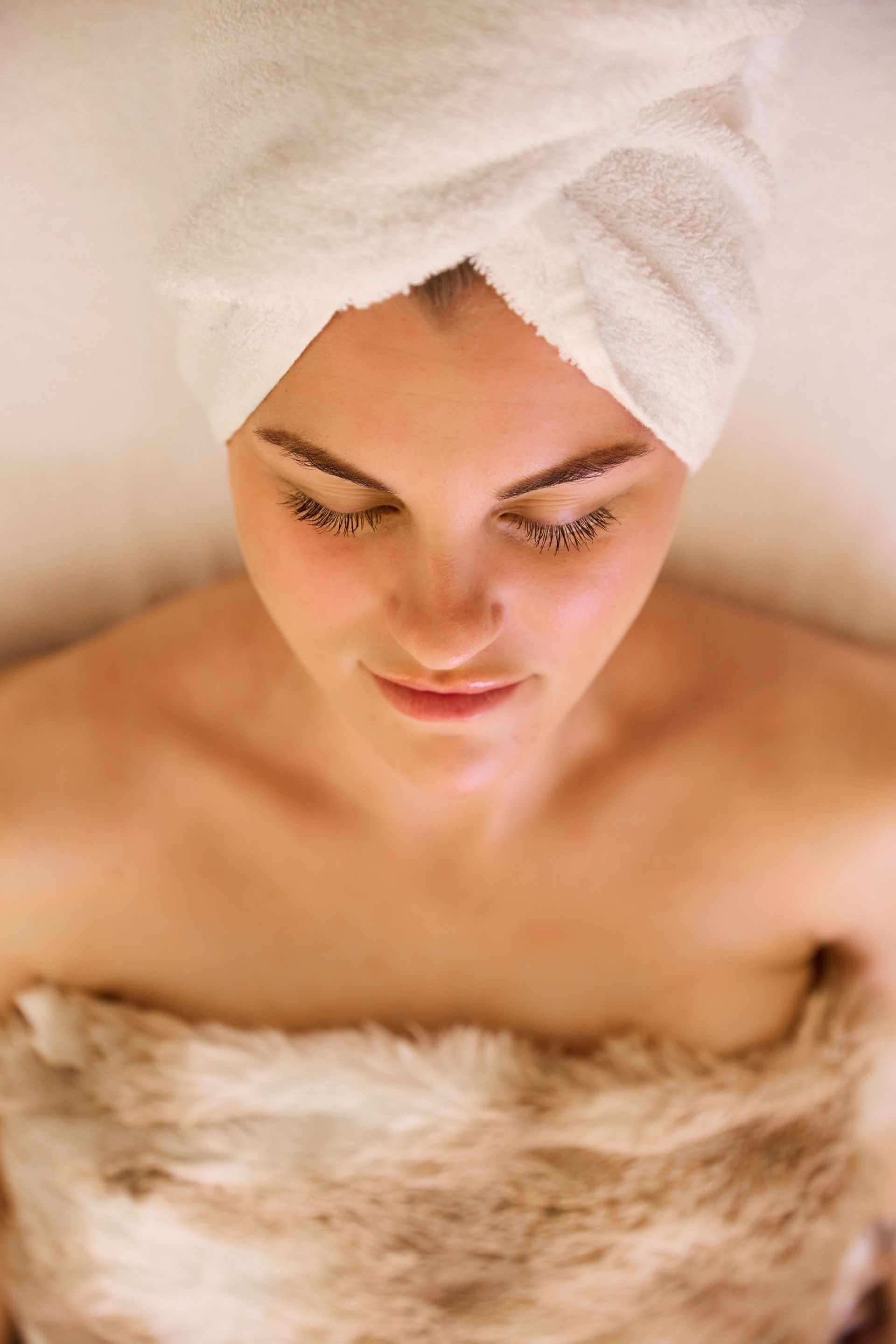 A woman is getting a facial massage at a spa.