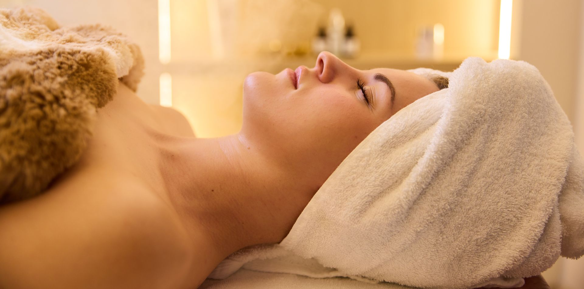Woman relaxing with a towel on her head, at Bain Beauty Skin Spa in Villa Rica, GA 30180