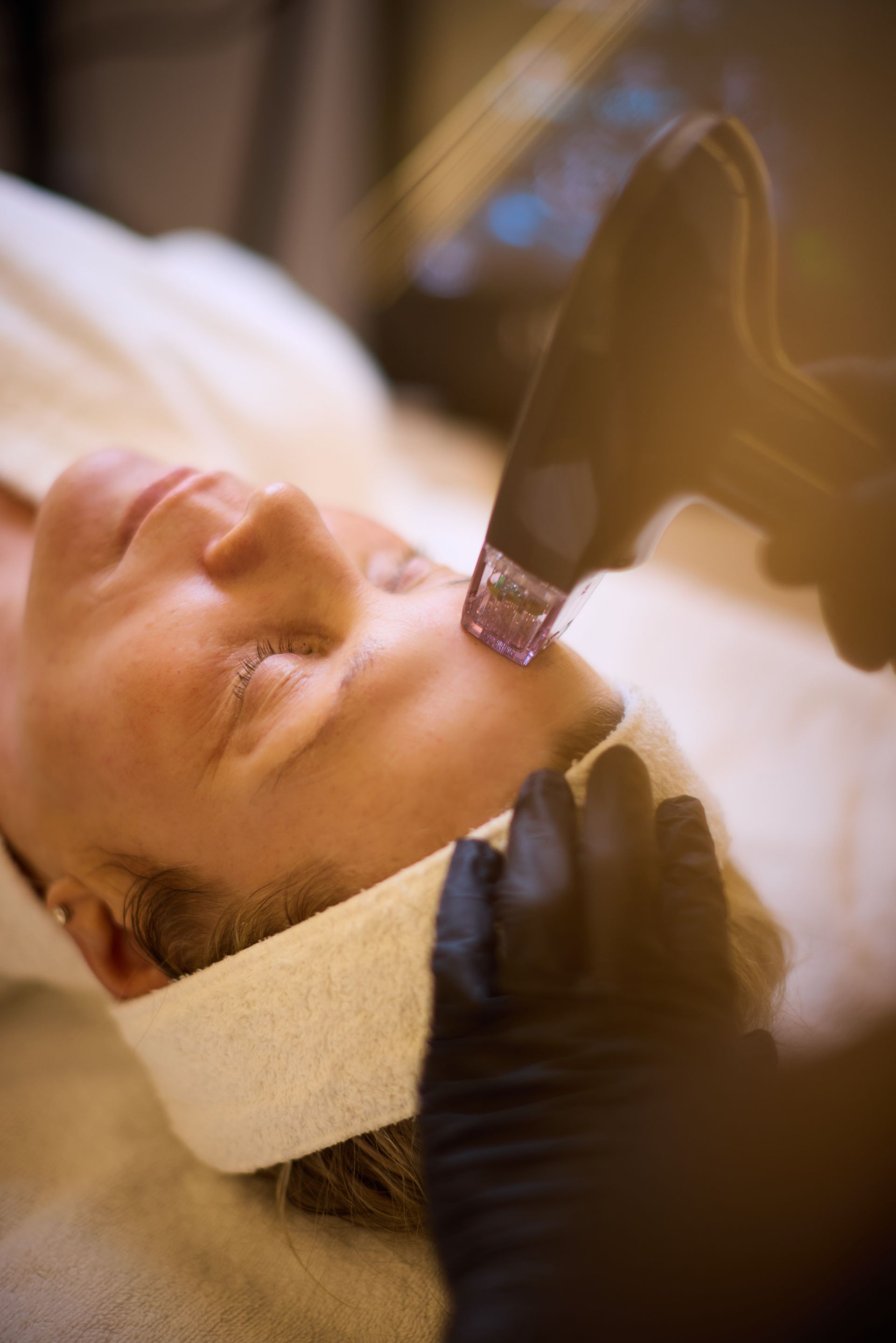A woman is getting a facial treatment at a spa.