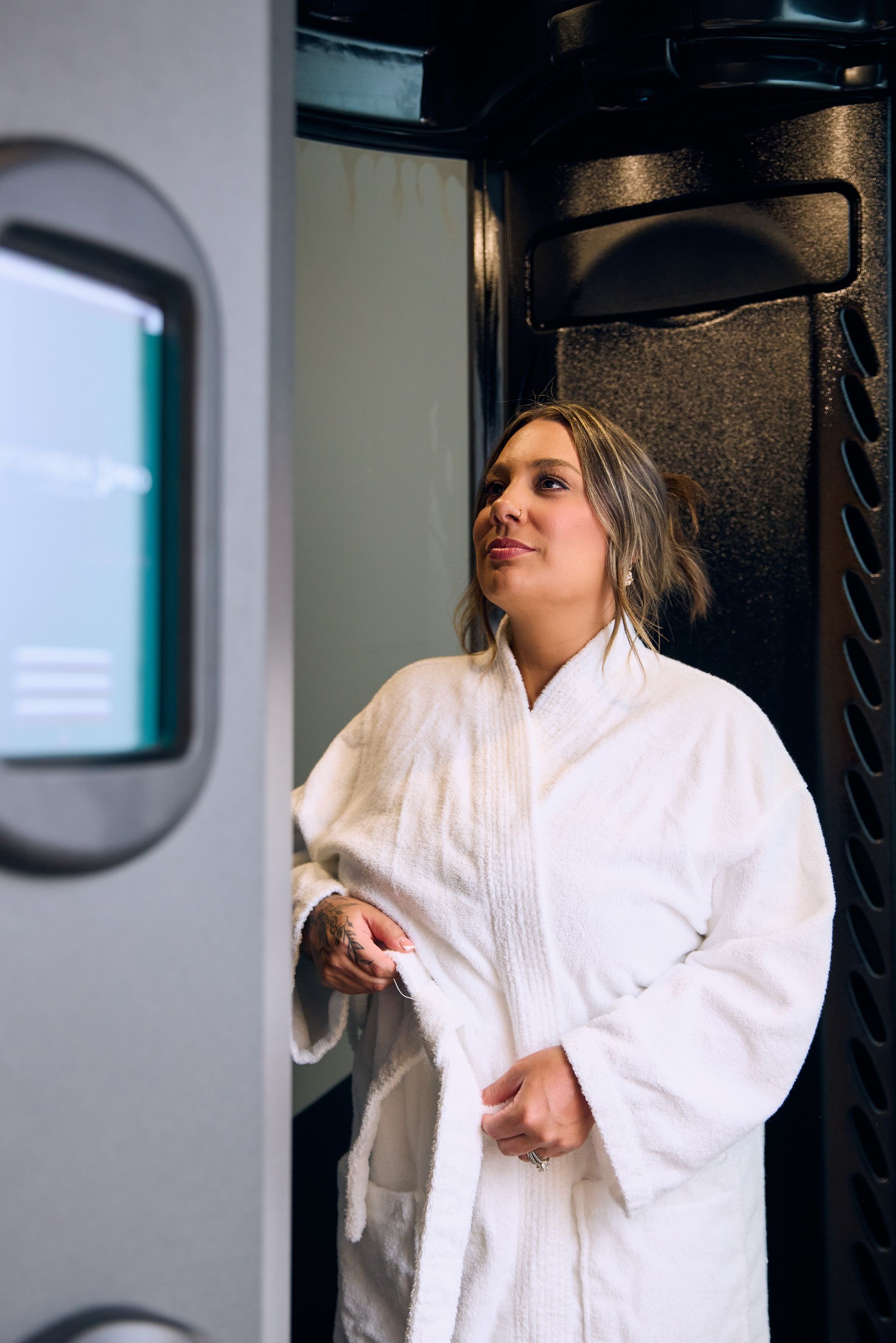 A woman is getting a massage in a spa with her eyes closed.