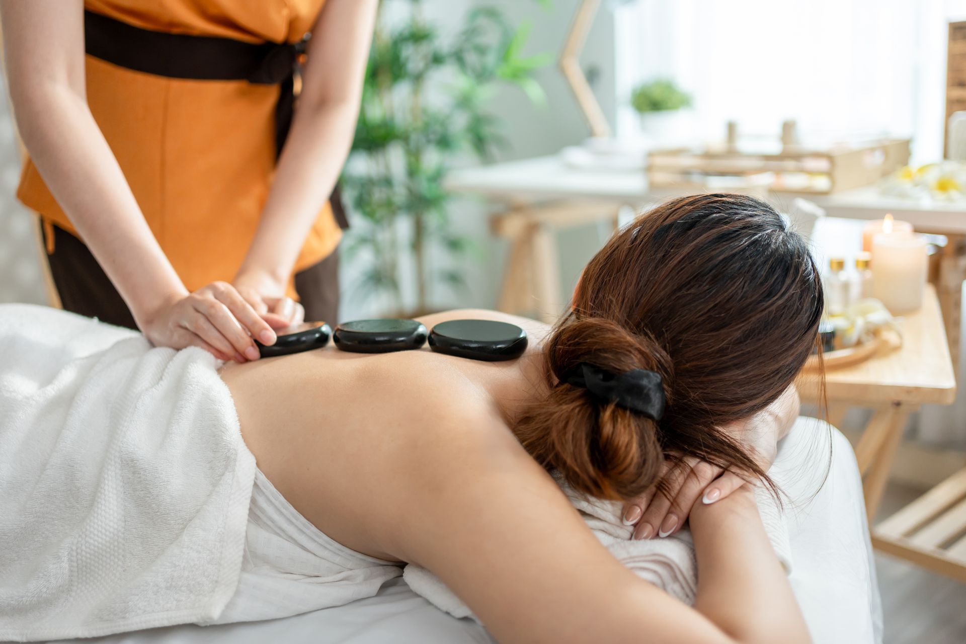 A man is sleeping on a couch with his eyes closed.