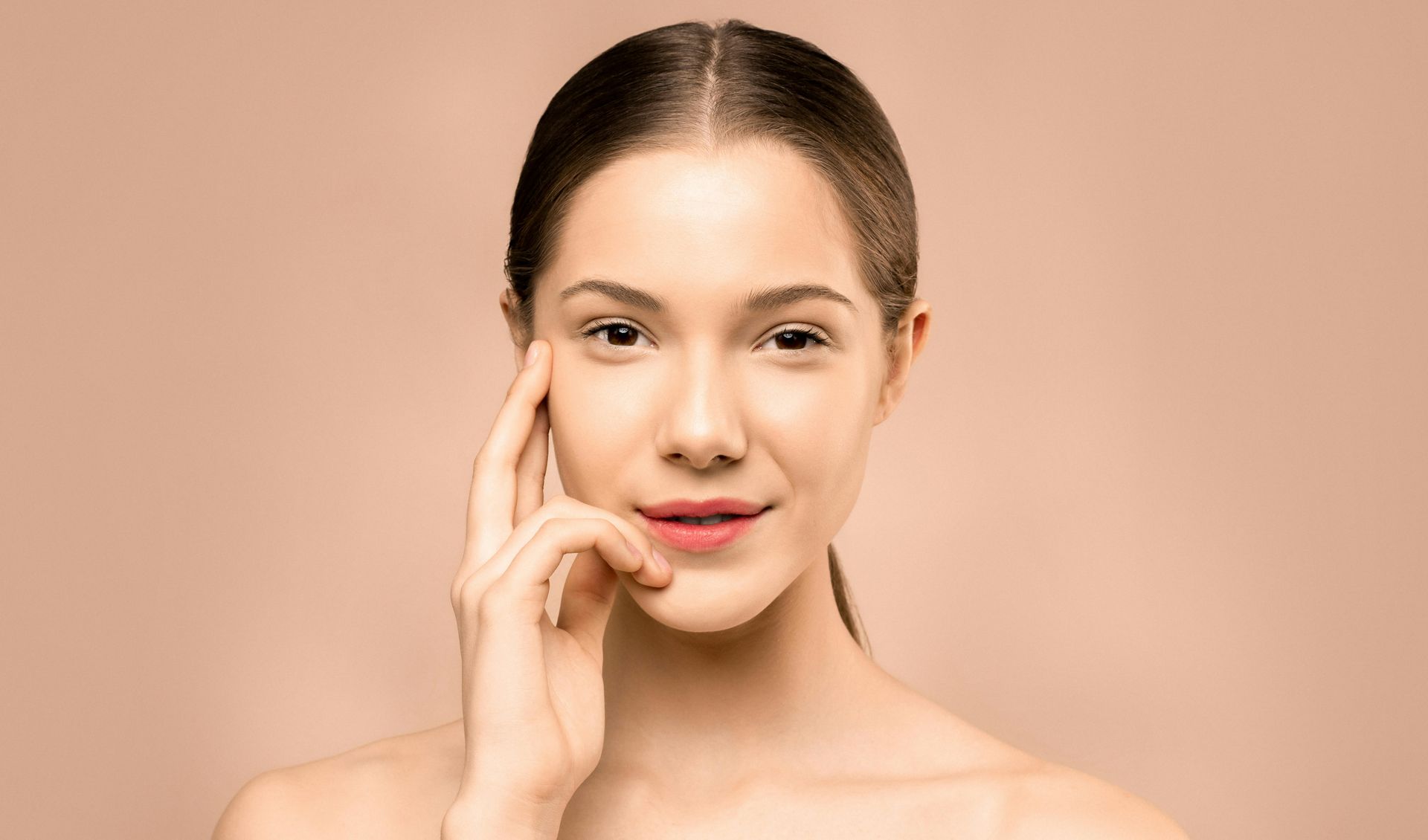 Woman looking at the camera, posing with her hair wrapped in a towel