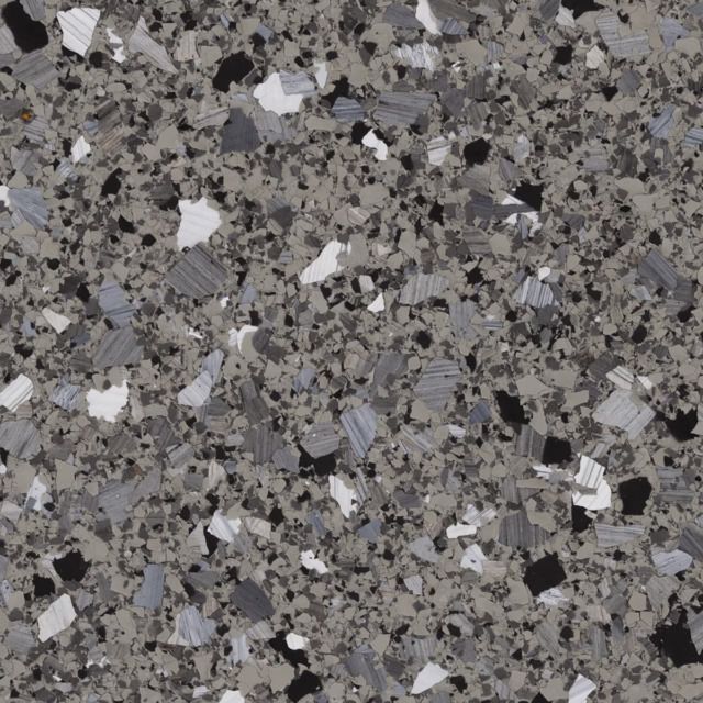 A close up of a gray and black granite counter top.