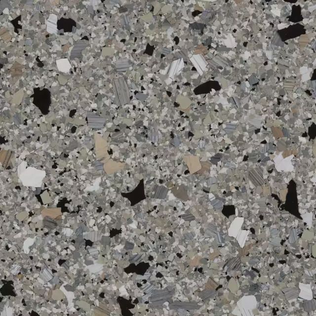 A close up of a gray and black granite counter top.