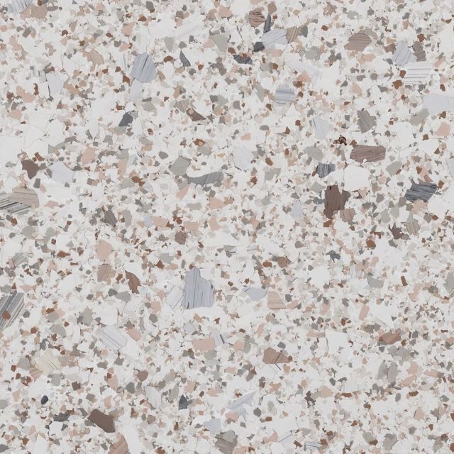 A close up of a white and brown granite counter top.