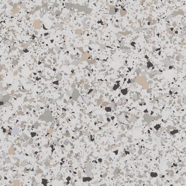A close up of a white granite counter top with black spots.