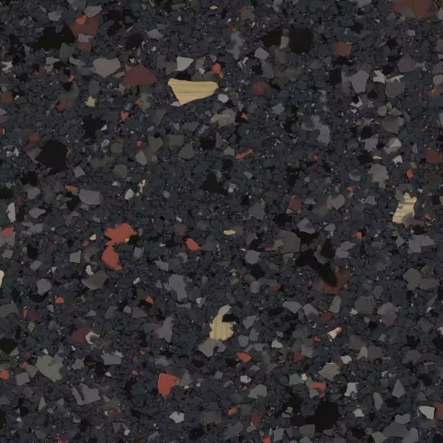 A close up of a black surface with a lot of small rocks on it