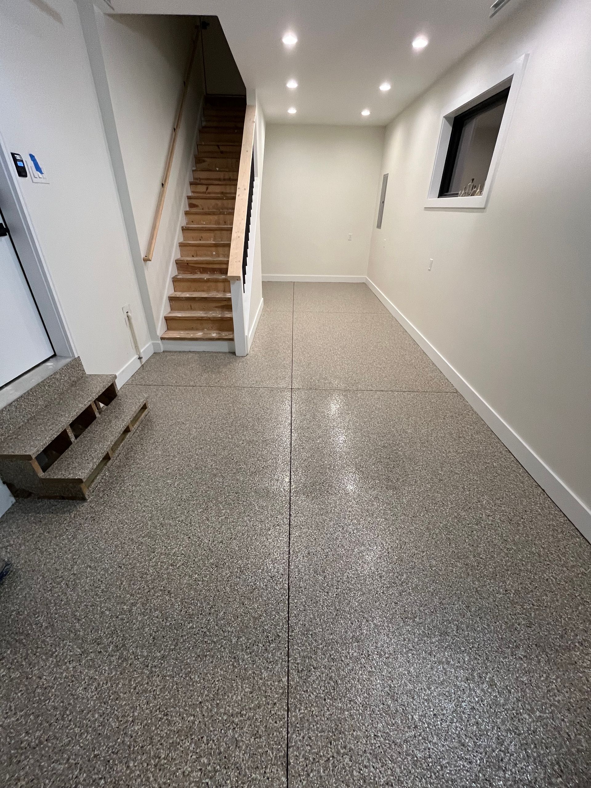 A hallway with stairs leading up to the second floor of a house.
