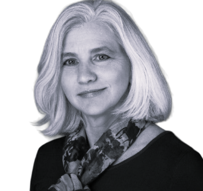 Portrait of a smiling woman with shoulder-length blonde hair, wearing a patterned scarf and dark top.
