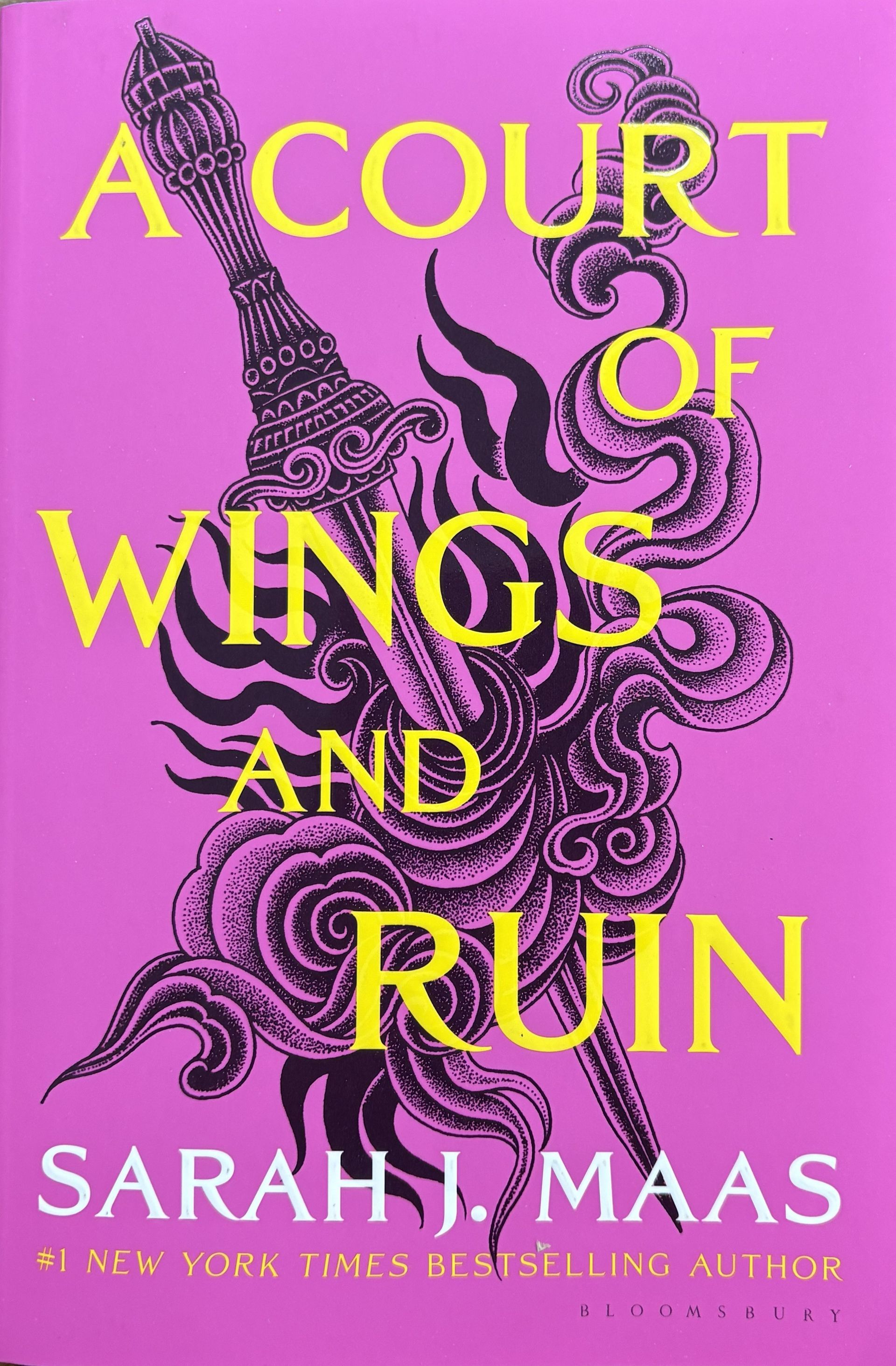 Cover for "A Court of Wings and Ruin" by Sarah J. Mass. Pink cover with sword through stipple art.