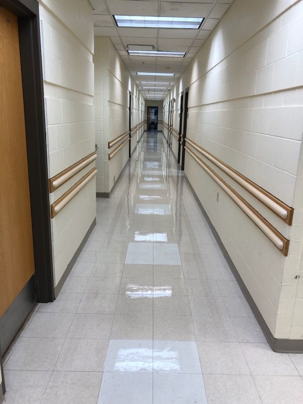 A long hallway with a wooden railing on the side